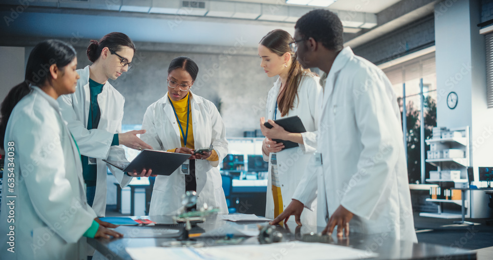 Poster Engineers In Lab Coats Using Laptop and Tablet, Brainstorming Ideas For Electronic Components. Diverse Team of Industrial Robotics Specialists Gathered Around a Table to Discuss a Blueprint.