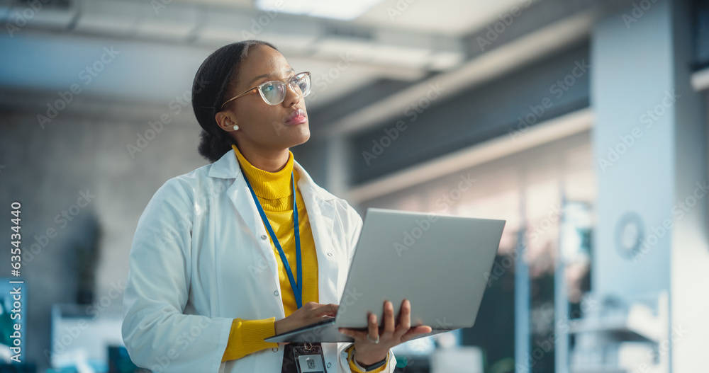 Aufkleber portrait of young black female specialist in a lab coat using laptop computer. professional and succ