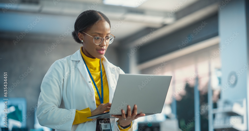 Aufkleber portrait of young black female specialist in a lab coat using laptop. professional and successful wo