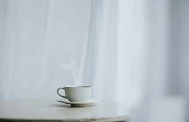 Cup of tea and saucer on table indoors