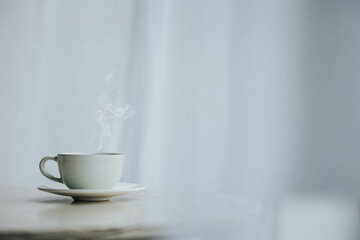Cup of tea and saucer on table indoors