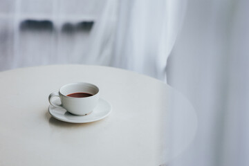 Cup of tea and saucer on table indoors
