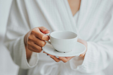 cup of hot coffee in female hands