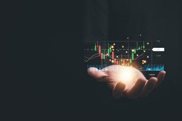 Delving into the intricacies of the stock market, a trader or investor focuses on their palm-held device, observing a candlestick chart and employing intelligent strategies for successful trading.