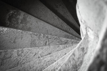 Close up shot of a stone spiral staircase in a French building - Powered by Adobe