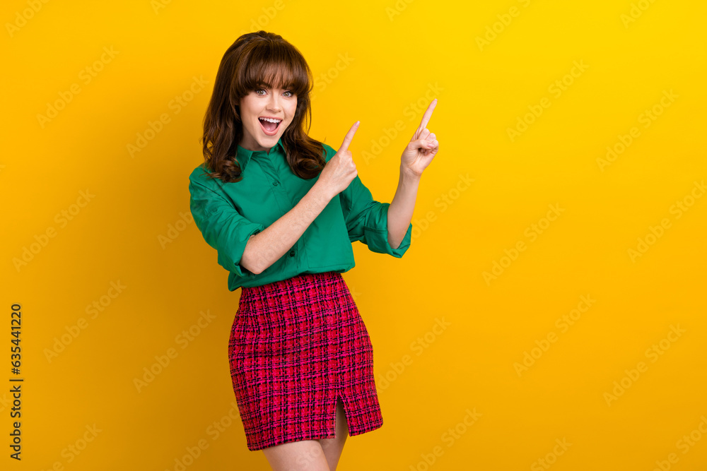 Sticker photo of adorable excited girl dressed green shirt showing two fingers empty space isolated yellow c