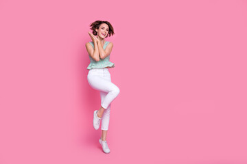 Full size photo of astonished cheerful girl stand one leg tiptoe empty space advert isolated on pink color background