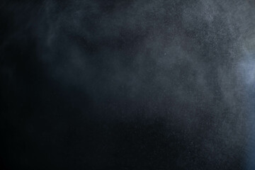 Water spray dust on dark background. Spraying mist effect isolated on black background. - obrazy, fototapety, plakaty