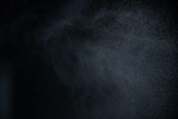 Water spray dust on dark background. Spraying mist effect isolated on black background. - obrazy, fototapety, plakaty