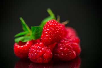 Sweet raspberry fruit isolated on black background