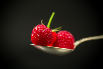 Sweet raspberry fruit isolated on black background