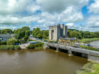 Fototapeta na wymiar Aerial view of Bunratty Castle large 15th-century tower house in County Clare in Ireland guarding the crossing on the Ralty river before it reaches the Shannon estuary