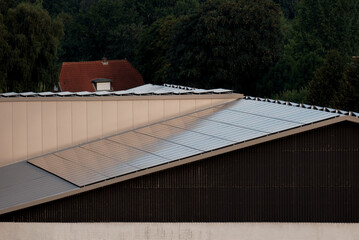 Warehouse with solar panels on the roof. Nature-produced energy. Sun-produced energy. Photovoltaic systems on the barn house in the countryside. Semiconductor technology. Carbonless footprint.