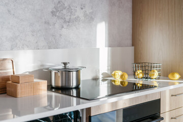 detail in stylish kitchen with induction hob and kitchenware