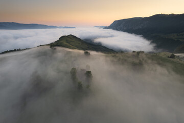 Summer aerial landscape above the foggy valley