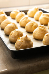 Freshly baked profiteroles on a plate. food concept. dessert. bakery.