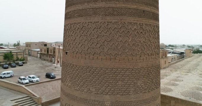 A drone flies around the famous memorial complex Kalyan Poi Kalon Complex and Poi Kalon Minaret, Poi Kalan or Po-i-Kalyan in Bukhara at dawn