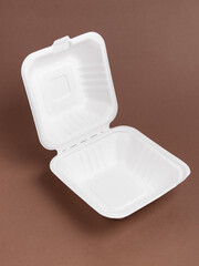 Disposable packaging for desserts or bento cake on brown background. Open box. Fast food