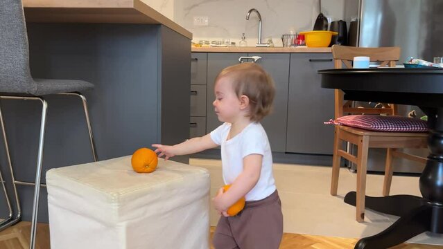 Adorable child playing with orange
