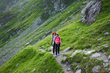 Fototapeta na wymiar Women hiking on a trail in the rocky mountains