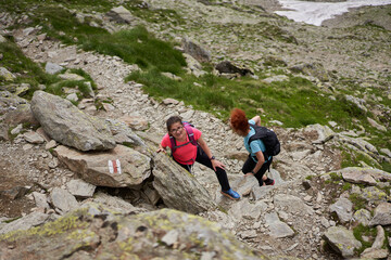 Women hiking on a trail in the rocky mountains