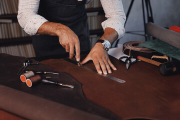 Tailor cobbler use natural brown leather, shoemaker working with skin textile in workshop