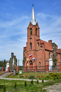 The historic Gothic red brick church with belfry in the village of Sokola Dabrowa
