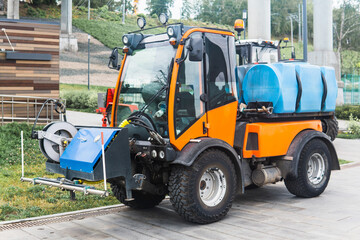 small tank truck for cleaning paths and watering plants in the city park
