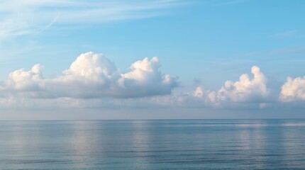 Obraz premium calm sea with blue sky and white clouds