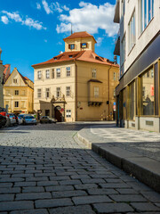 Cobblestone street and typical house in old town of Prague.