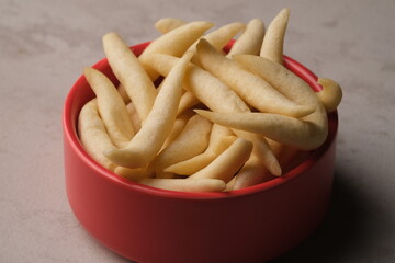 telur gabus keju. cheese scrambled eggs in red bowl. savory snack from Indonesia. 