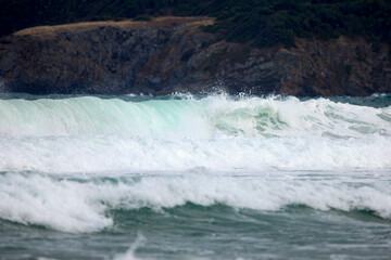 Abstract landscape with sea waves at the shore on a windy day.