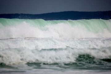 Abstract landscape with sea waves at the shore on a windy day.
