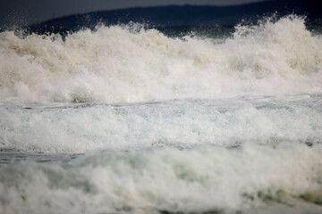 Abstract landscape with sea waves at the shore on a windy day.