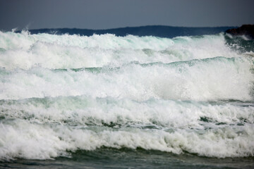 Abstract landscape with sea waves at the shore on a windy day.