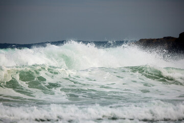 Abstract landscape with sea waves at the shore on a windy day.