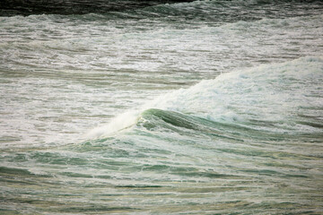 Abstract landscape with sea waves at the shore on a windy day.