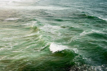Abstract landscape with sea waves at the shore on a windy day.