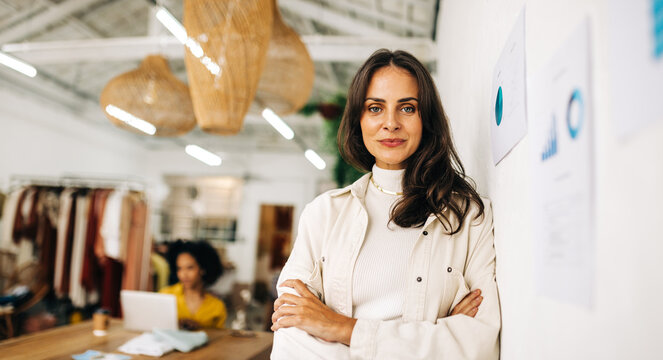 Business Confidence: Small Business Owner Looking At The Camera With Crossed Arms