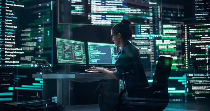Female Developer Thinking and Typing on Computer, Surrounded by Big Screens Showing Coding Language. Professional Programmer Creating Software, Running Coding Tests. Futuristic Concept of Programming
