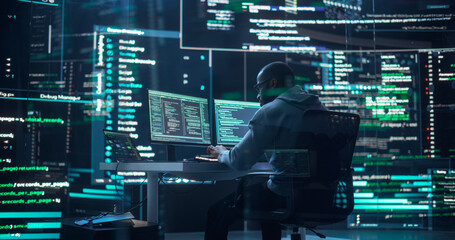 Black Male Developer Typing on Computer, Surrounded by Transparent Screens Showing Code Lines....