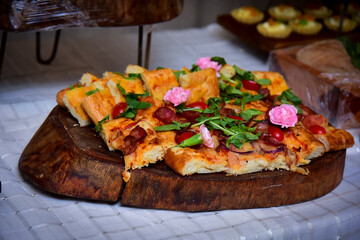 pepperoni pizza with arugula, tomato and edible flowers, pizza,  gastronomy background, food background	