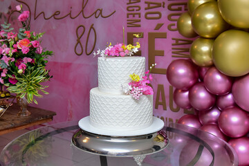 party hall decorated with flowers and cake table, fondant cake, closeup on flowers on birthday...