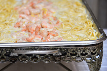 pasta with seafood, pasta on a wooden table, shrimp with spaghetti in cheese sauce, shrimp in white...