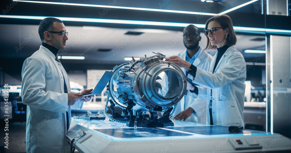 Aufkleber Diverse Multiethnic Team of Industrial Engineers Gathered Around a Table With an Innovative Turbine Engine. Scientists Use Tablet Computer to Research, Develop and Program the Futuristic Motor