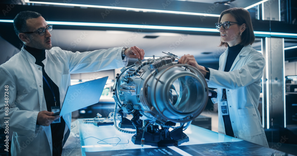 Poster Professional Multicultural Team of Female and Male Engineers Working On Industrial Jet Turbine in Factory Development Workshop. Tech Facility with Machines, Computers and Research Equipment