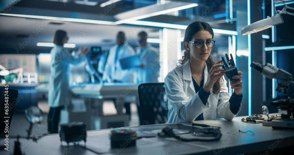 Poster Talented Young Female Scientist Working on a Prosthetic Robotic Hand. On Blurred Background Diverse Team of Industrial Specialists Working on Advanced Mobility Robot Dog with Artificial Intelligence