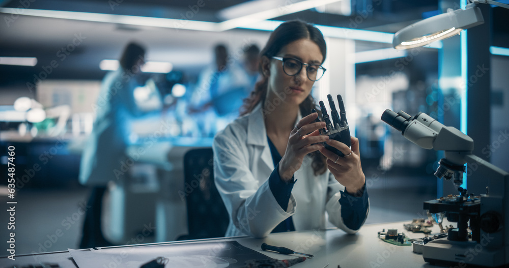 Fototapete Portrait of a Young Female Scientist Working in Technological Research and Development Company, Assembling an Innovative Bionic Prosthetic Hand. Engineer Working on Technology for Physically Impaired