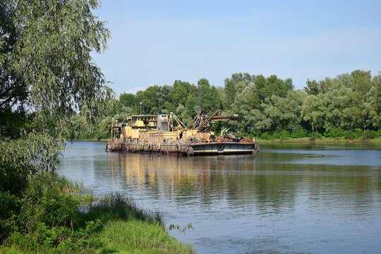 Extraction of sand by a dredge in the river.