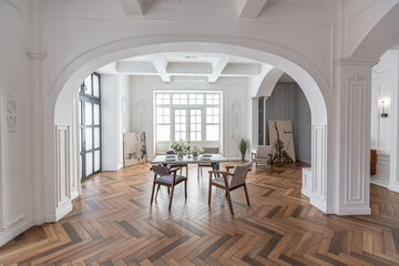 a chic expensive bright interior of a huge living room in a historic mansion with arched arches,...